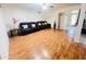 Comfortable living room with wood floors and a plush black reclining sofa at 2115 W Myrtle Ave, Phoenix, AZ 85021