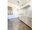 Spacious room with white brick walls, white cabinets, and a door to the outside at 2115 W Myrtle Ave, Phoenix, AZ 85021