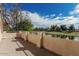 Balcony view showcasing landscaping, a lake, and a golf course with an expansive sky in the background at 2134 W Peninsula Cir, Chandler, AZ 85248