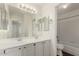 Bright bathroom featuring a double sink vanity, decorative mirrors, and shower-tub combo at 2134 W Peninsula Cir, Chandler, AZ 85248