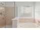 Bathroom featuring bathtub, shower, and window at 2134 W Peninsula Cir, Chandler, AZ 85248