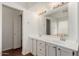 Bathroom featuring double sinks, vanity, lighting, and separate room with tub at 2134 W Peninsula Cir, Chandler, AZ 85248
