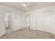 Neutral bedroom featuring plush carpet, an adjacent room, and an oversized closet with sliding doors at 2134 W Peninsula Cir, Chandler, AZ 85248