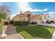 Charming single-story home with a lush green lawn, complemented by desert landscaping and a two-car garage at 2134 W Peninsula Cir, Chandler, AZ 85248