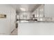 Bright kitchen featuring white cabinetry, granite countertops, and modern appliances at 2134 W Peninsula Cir, Chandler, AZ 85248