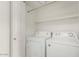 Laundry room featuring washer, dryer, shelving, and a door at 2134 W Peninsula Cir, Chandler, AZ 85248
