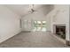 Bright living room with a fireplace and sliding glass doors providing peaceful water views at 2134 W Peninsula Cir, Chandler, AZ 85248