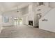 Spacious living room with a cozy fireplace, high ceilings, and large windows overlooking a serene outdoor space at 2134 W Peninsula Cir, Chandler, AZ 85248