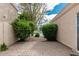 Secluded brick patio offers a peaceful retreat with views of a lush landscaped yard and tranquil scenery at 2134 W Peninsula Cir, Chandler, AZ 85248