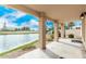 Covered patio view of serene waterfront, offering tranquil outdoor living with manicured lawn and lush landscaping at 2134 W Peninsula Cir, Chandler, AZ 85248
