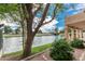 Scenic waterfront view featuring a landscaped shoreline, mature trees, and nearby bridge. A true oasis at 2134 W Peninsula Cir, Chandler, AZ 85248