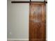 Close-up of rustic barn door with wood grain detailing and hardware at 2150 W Alameda Rd # 1109, Phoenix, AZ 85085