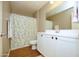 Bright bathroom features a white sink and cabinet and a shower and bath with a neutral floral shower curtain at 2150 W Alameda Rd # 1109, Phoenix, AZ 85085