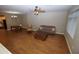 Spacious living room featuring wood flooring, a ceiling fan, and furniture at 2150 W Alameda Rd # 1109, Phoenix, AZ 85085