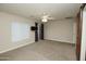 Open main bedroom with carpet, ceiling fan, wall-mounted tv, and rustic barn door at 2150 W Alameda Rd # 1109, Phoenix, AZ 85085