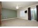 Large carpeted main bedroom with ceiling fan, patio door and modern barn door at 2150 W Alameda Rd # 1109, Phoenix, AZ 85085