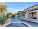 Stunning backyard featuring a sparkling pool, spa, lush landscaping, and a covered patio area at 22317 N 39Th Run, Phoenix, AZ 85050
