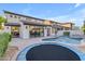 Expansive backyard with pool, trampoline, covered patio, and seamless indoor-outdoor living at 22317 N 39Th Run, Phoenix, AZ 85050