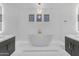 Sleek bathroom features a freestanding tub, dual vanities, and modern fixtures at 22317 N 39Th Run, Phoenix, AZ 85050