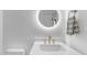 Bright bathroom featuring a modern vanity, round mirror with backlight, and stylish gold hardware at 22317 N 39Th Run, Phoenix, AZ 85050