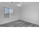 Neutral bedroom features a ceiling fan, window, and wood-look floors at 22317 N 39Th Run, Phoenix, AZ 85050