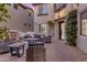 Inviting outdoor courtyard with patio furniture, water feature, and lush greenery at 22317 N 39Th Run, Phoenix, AZ 85050