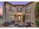 Inviting outdoor courtyard with patio furniture, string lights, and lush greenery at 22317 N 39Th Run, Phoenix, AZ 85050