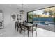 Bright dining room features large window views of backyard pool and water feature at 22317 N 39Th Run, Phoenix, AZ 85050