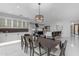 Elegant dining room featuring a large dining table with view into the kitchen and living areas at 22317 N 39Th Run, Phoenix, AZ 85050