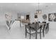 Open-concept dining room with views of the kitchen, living room, and fireplace at 22317 N 39Th Run, Phoenix, AZ 85050