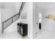 Bright foyer with staircase, modern console table, and stylish decor leading to the office and bathroom at 22317 N 39Th Run, Phoenix, AZ 85050