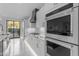 Contemporary kitchen with stainless steel appliances, ample storage, and access to the backyard at 22317 N 39Th Run, Phoenix, AZ 85050