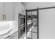 Modern kitchen featuring stainless steel double oven and access to the pantry through a sliding barn door at 22317 N 39Th Run, Phoenix, AZ 85050