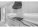 Bright kitchen featuring white cabinetry, modern countertops, and stainless steel stove at 22317 N 39Th Run, Phoenix, AZ 85050