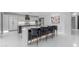 Modern kitchen featuring a striking waterfall island, stylish seating, and sleek white cabinetry at 22317 N 39Th Run, Phoenix, AZ 85050