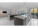 Spacious kitchen with waterfall island, stainless steel appliances, and view to the dining and living areas at 22317 N 39Th Run, Phoenix, AZ 85050