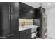Well-organized laundry room equipped with sink, storage, and stacked washer/dryer at 22317 N 39Th Run, Phoenix, AZ 85050