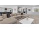 Open-concept living area with sleek staircase, designer furnishings, and easy access to kitchen and entry at 22317 N 39Th Run, Phoenix, AZ 85050