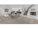Spacious living room with plush carpeting, contemporary staircase, and open floor plan to the gourmet kitchen at 22317 N 39Th Run, Phoenix, AZ 85050