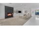 Inviting living room with cozy fireplace, neutral color palette, and seamless transition to the dining area at 22317 N 39Th Run, Phoenix, AZ 85050