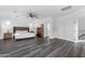 Spacious main bedroom features dark luxury vinyl flooring and a ceiling fan at 22317 N 39Th Run, Phoenix, AZ 85050