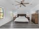 Bright main bedroom boasts a ceiling fan, ample natural light, and wood-look floors at 22317 N 39Th Run, Phoenix, AZ 85050