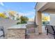 An outdoor kitchen with a stainless steel grill and a stone-clad counter on a brick patio at 22317 N 39Th Run, Phoenix, AZ 85050