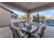 Covered patio featuring comfortable seating, outdoor dining table, and views of the beautiful pool and fountain at 22317 N 39Th Run, Phoenix, AZ 85050