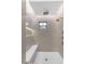 Neutral-toned walk-in shower includes a window, bench, and dual shower heads at 22317 N 39Th Run, Phoenix, AZ 85050