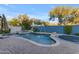 Inviting pool area with water features, a spa, lush landscaping, and a blue trampoline at 22317 N 39Th Run, Phoenix, AZ 85050