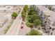Overhead view of a modern residential community with manicured lawns, colorful flowers, and lush trees at 2402 E 5Th St # 1498, Tempe, AZ 85288