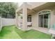Spacious backyard with artificial grass, covered patio, offering an inviting outdoor space at 2402 E 5Th St # 1498, Tempe, AZ 85288