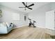 Well-lit bedroom with a cozy chair, modern artwork, and an exercise bike creates a versatile space at 2402 E 5Th St # 1498, Tempe, AZ 85288