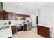 Well-lit kitchen with stainless steel appliances, dark wood cabinets and sleek countertops at 2402 E 5Th St # 1498, Tempe, AZ 85288